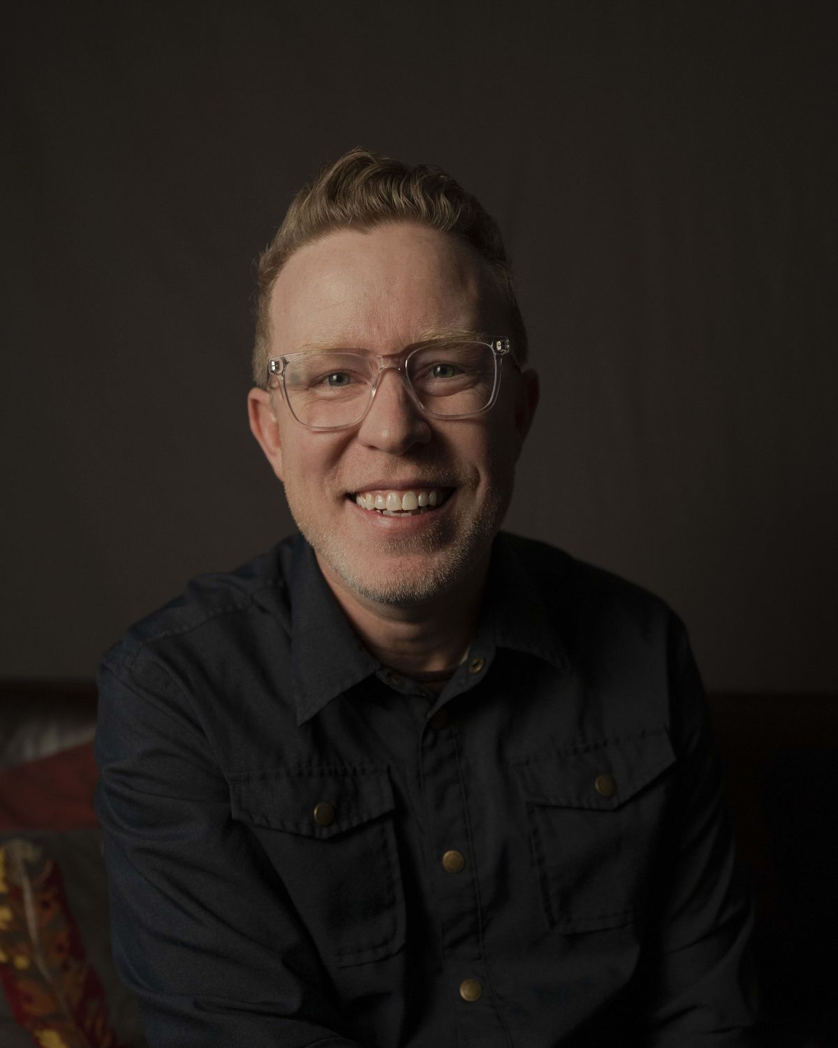 David Walker, smiling, in a dark shirt and glasses